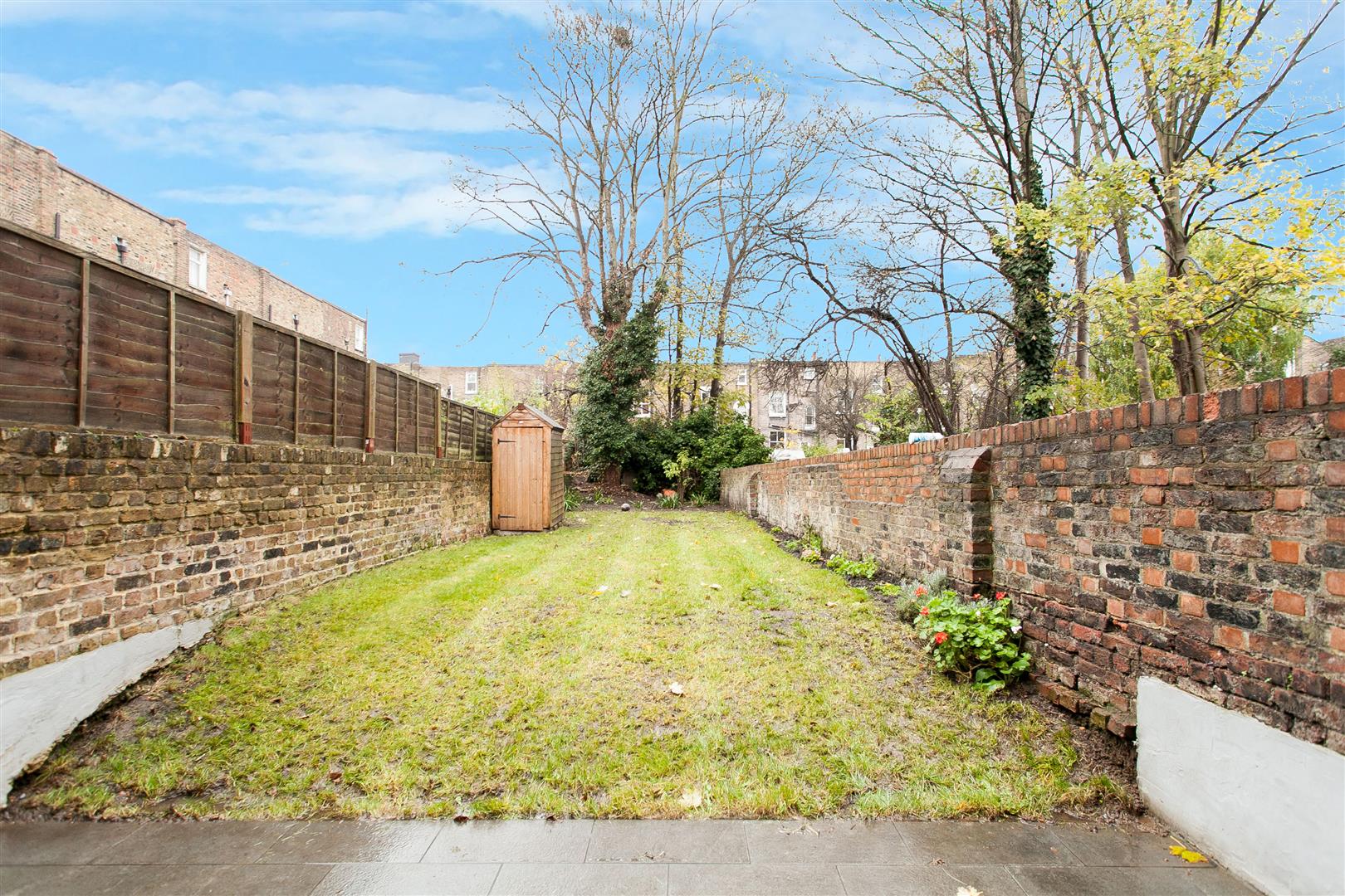 A photo of private garden featuring perfectly cut lawn that was recently sold at Davies & Davies